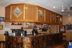 a bar in a restaurant with bar stools at O Lar de Carmiña in Devesa