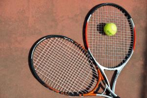 a tennis racket and a tennis ball on a court at Sundia By Liberty Suncity in Oludeniz