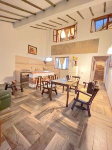 a living room with wooden tables and chairs at Villa villa in Villa de Leyva