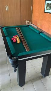 a green pool table with fruit on top of it at LINDA CHACARA EM CONDO A 40 MIN DE SP com piscina climatizada, churrasqueira, wifi, 5 quartos e muita natureza in Cajamar