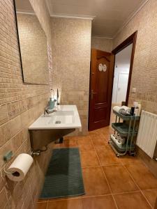 a bathroom with a sink and a mirror at Gurtxu Rooms by Sun Sebastián in San Sebastián