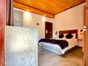 a bedroom with a large bed in a room at Casa Palmeira in Pipa
