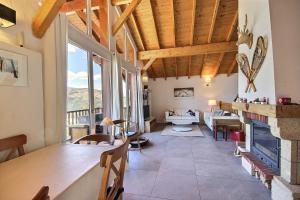 ein Wohnzimmer mit einem Tisch und einem Kamin in der Unterkunft Chalet La Plagne Montalbert 50m des pistes in La Plagne Tarentaise