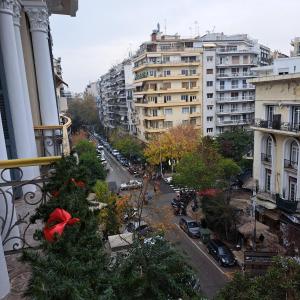 a christmas tree on a city street with buildings at Maria's apartments in Thessaloniki
