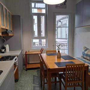 a kitchen and dining room with a table and chairs at Maria's apartments in Thessaloniki