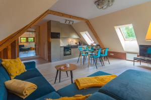 a living room with a blue couch and a table at Trevilles Art-Deco Józefina in Szklarska Poręba