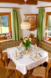 a dining room table with a white table cloth at Apartment Sigrid in Arriach