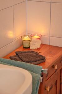 a bathroom with two candles on a counter with a sink at Apartment Sigrid in Arriach