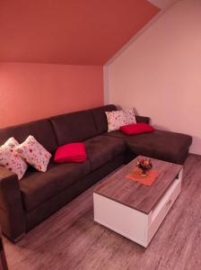 a living room with a brown couch and a coffee table at Sonja´s Ferienwohnung in Patergassen