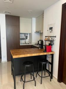 a kitchen with two bar stools and a counter top at New Luxury Modern Canal View. in Dubai