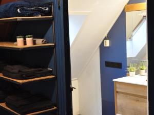 a bathroom with a black closet under the stairs at Spend the night in an old flour factory in Haulerwijk