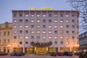 a building with a sign on top of it at Imperial Hotel Ostrava in Ostrava