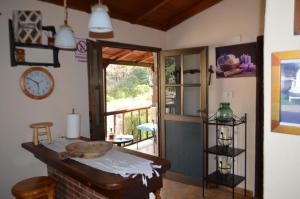a room with a table and a clock and a door at Casa Jonay in Hermigua