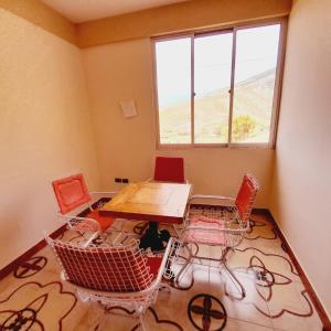 a room with a table and chairs and a window at HOSTAL EDEN in Torotoro