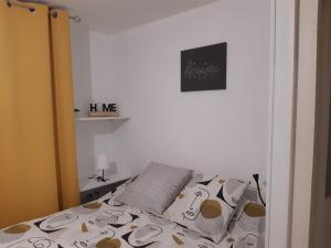 a bedroom with a bed with hello kitty pillows at Joli appartement T2 Agglo Troyes in Sainte-Savine