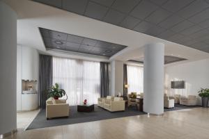 a lobby with couches and a table in a building at Imperial Hotel Ostrava in Ostrava