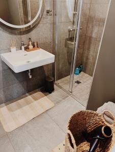 a bathroom with a sink and a shower at Breeze Albatross in Ķesterciems