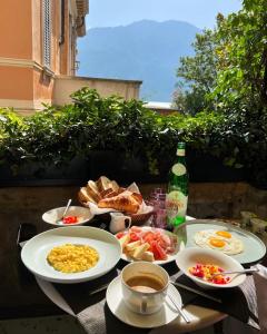 a table with plates of food and a bottle of wine at Casa L'Andrunèl in Limone sul Garda