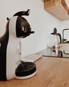 a black and white mixer sitting on a kitchen counter at Breeze Albatross in Ķesterciems