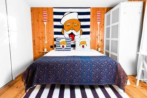 a bedroom with a santa claus head on the bed at Beach House in Lège-Cap-Ferret