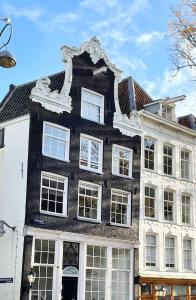 a black and white building with a white facade at Little Tulip in Amsterdam