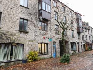 a stone building with a tree in front of it at River Walk in Kendal