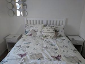 a bedroom with a bed with butterflies on it at Ecky-Thump pet friendly holiday chalet in Bridlington