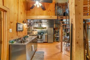 a large kitchen with wooden walls and wooden floors at Stratton Woods in West Wardsboro