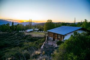 a solar roof on top of a house on a hill at Cabañas Premium Mirador Azul in Potrerillos