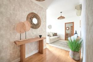 a living room with a table and a couch at Apartment with Private Terrace & Car Garage in Lisbon