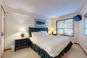 a bedroom with a large bed and a window at Aspens by WB Vacation Rentals in Whistler +75 photos