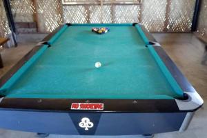 a green pool table with a ball on it at Bancudo Cabin and Resort in Karasanan