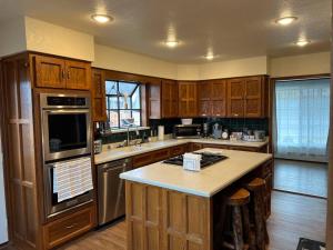 a kitchen with wooden cabinets and a counter top at 2min from rt66 hot tub bocceball court firepit in Williams