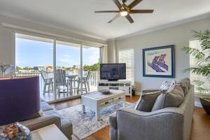 a living room with a couch and a tv and a table at 204 Bay Harbor in Clearwater Beach