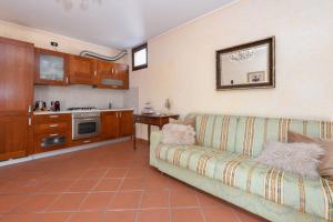 a living room with a couch and a kitchen at Prestige Apartment in Sirmione +21 photos
