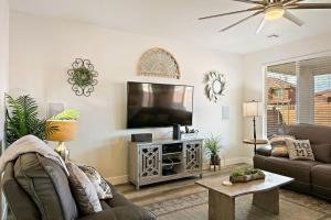 a living room with a flat screen tv on a wall at Blooming Cactus home in Washington