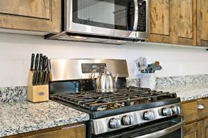 a kitchen with a stove with a tea kettle on it at Blooming Cactus home in Washington