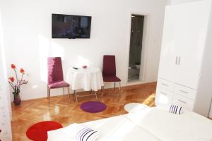 uma sala de jantar com uma mesa e duas cadeiras em Rooms Miletic near the Palace em Split