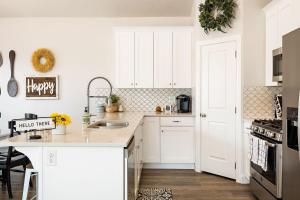 a kitchen with white cabinets and a counter top at Zion Sunrise townhouse in Washington