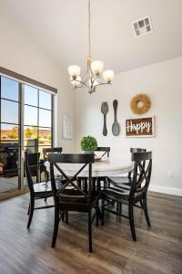 a dining room with a table and chairs at Zion Sunrise townhouse in Washington +26 photos
