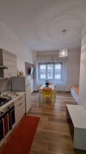 a kitchen with a table and a dining room at Enne's Apartments in the heart of Palermo in Palermo