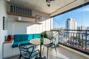 uma sala de estar com um sofá azul e uma mesa em VO13 - Apto Luxuoso e Aconchegante no Bom Retiro: Conforto em São Paulo