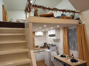 a small kitchen with a staircase in a tiny house at Tiny House in Narva-Jõesuu