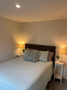 a bedroom with a large bed with two night stands at 2 Bedroom Coastal Home in SLO in San Luis Obispo