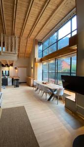 a large room with tables and chairs and windows at Ca de Palomera Vall d’Aran in Les