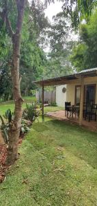 a house with a table and a bench in a yard at Oasis at Burringbar waterfront holiday 