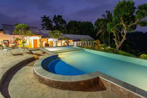 a swimming pool in the backyard of a house at Pondok Guru Bakti Cottage in Senaru