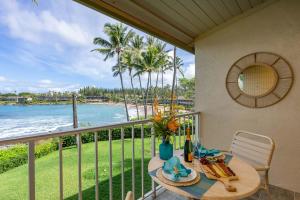 a table on a balcony with a view of the ocean at Napili Shores A202 OF Studio condo in Kahana