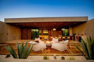 a living room with a couch and a fire place at Casa Malbec, Valle de Guadalupe in Valle de Guadalupe