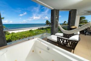 a bathtub with a view of the ocean at Stunning Ocean Front By Condo Boutique in Playa del Carmen